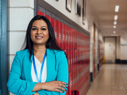 Teacher with lanyard in school corridor