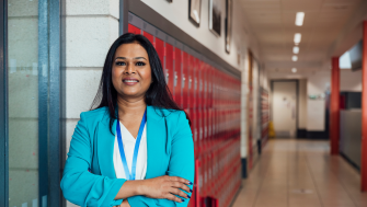 Teacher with lanyard in school corridor